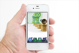 Euro coins and euro banknotes on the display of a smartphone