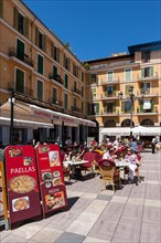 Central street cafes offering paella on Placa de Major square