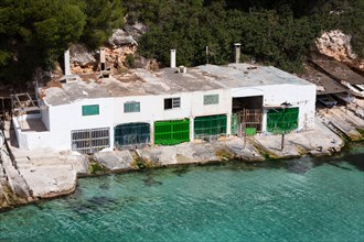 Boat house in the bay of Cala Pi