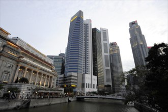 The Fullerton Hotel on Singapore River with Skyscrapers of the Financial District