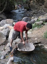 Man stirring volcanic mineral mud