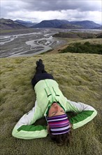 Young woman lying in a moss landscape