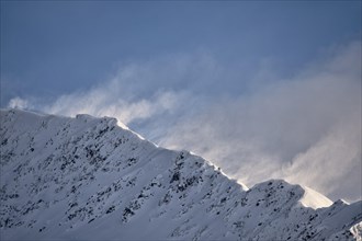 High winds blast a ridge in the Chugach Range