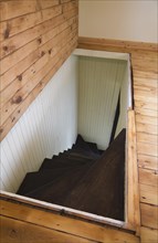 Trap door for wooden staircase leading to the downstairs floor of an old Canadiana cottage style residential home