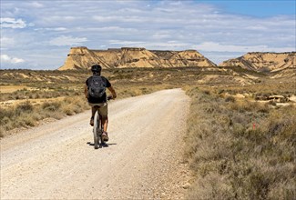 Cyclist on a road in Bardenas Reales desert