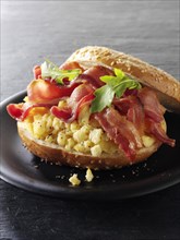 Crispy bacon and scrambled eggs on a bagel