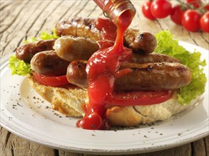 Traditional chipolata pork sausages with tomato ketchup sandwich