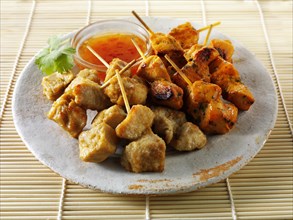Traditional oriental satay with chilli dipping sauce