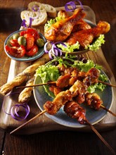 Party buffet food with chicken satay and BBQ drum sticks