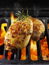 Chicken thighs cooking on a BBQ