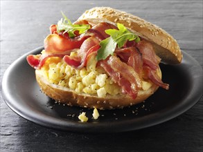 Crispy bacon and scrambled eggs on a bagel