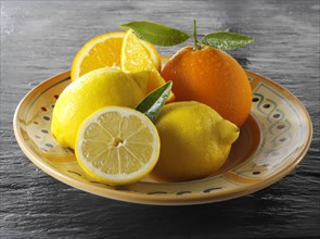 Fresh whole and cut oranges and lemons