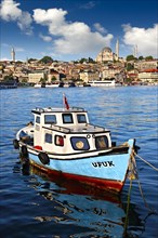 Fishing boat in the Golden Horn on the Galata banks looking towards the Suleymaniye Mosque