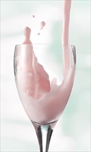 Fresh flavoured milk being poured into a glass