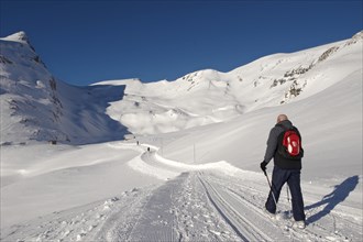 Walker in the snow in the mountains near Grindelwald First
