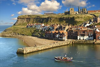Whitby harbour with Whitby Abbey on the headland