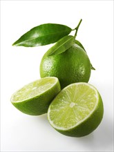 Fresh whole and cut lime fruit with leaves