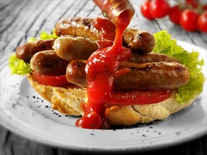 Traditional chipolata pork sausages with tomato ketchup sandwich