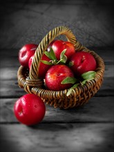 Red plums in a basket