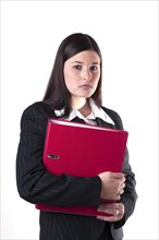 Businesswoman holding a red folder in her arm