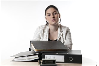 Office worker sitting at a desk with files
