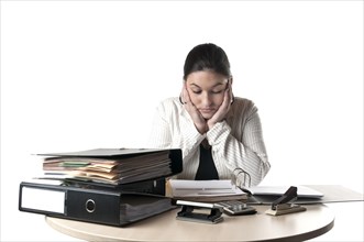 Office worker sitting at a desk with files