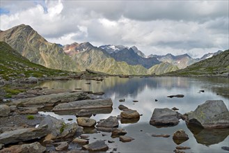 Mountain lake at Timmelsjoch looking towards the Stubai Alps