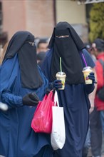 Veiled women on a shopping spree