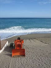 Excavator on a beach on the Italian Riviera