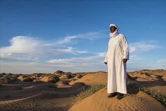Beduin man in the desert in evening light