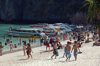 Speedboats and mass tourism on the sandy beach of Maya Beach