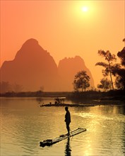 Fisherman on a bamboo raft on the Li Jiang River