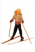 Doll with ski clothing and skis
