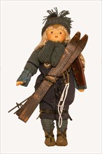 Doll with historical ski clothing and skis
