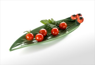 Cherry tomatoes in an elongated leaf-shaped bowl