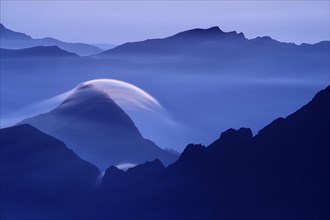 Peaks at the blue hour with rolling cloud