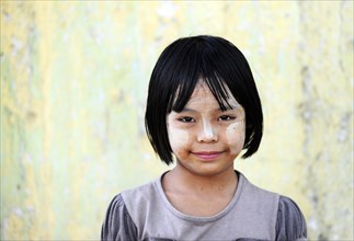 Girl with thanaka paste on her face