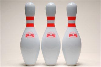 Three bowling pins lined up together