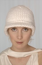 Blond woman with a white woolly hat