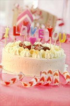 Cake with letter candles spelling the message I love you