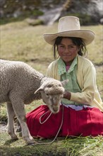 Peruvian shepherd girl with a straw hat
