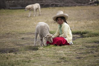 Peruvian shepherd girl with a straw hat