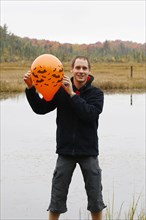 Man holding a Halloween balloon