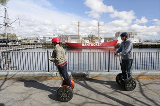 Tourists riding segways round the port