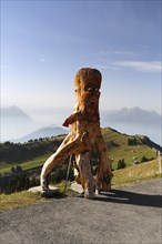 Wooden figure as a guide to a cheese factory