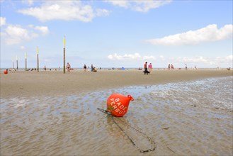 Buoy marked 'Baden Verboten' or 'No Swimming' on the beach of St. Peter-Ording