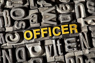 Old lead letters forming the word OFFICER