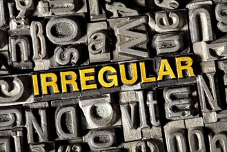 Old lead letters forming the word IRREGULAR