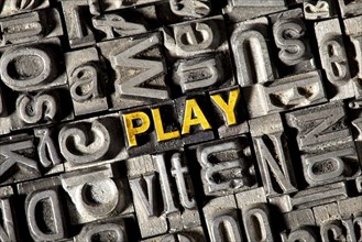 Old lead letters forming the word PLAY