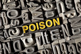 Old lead letters forming the word 'POISON'